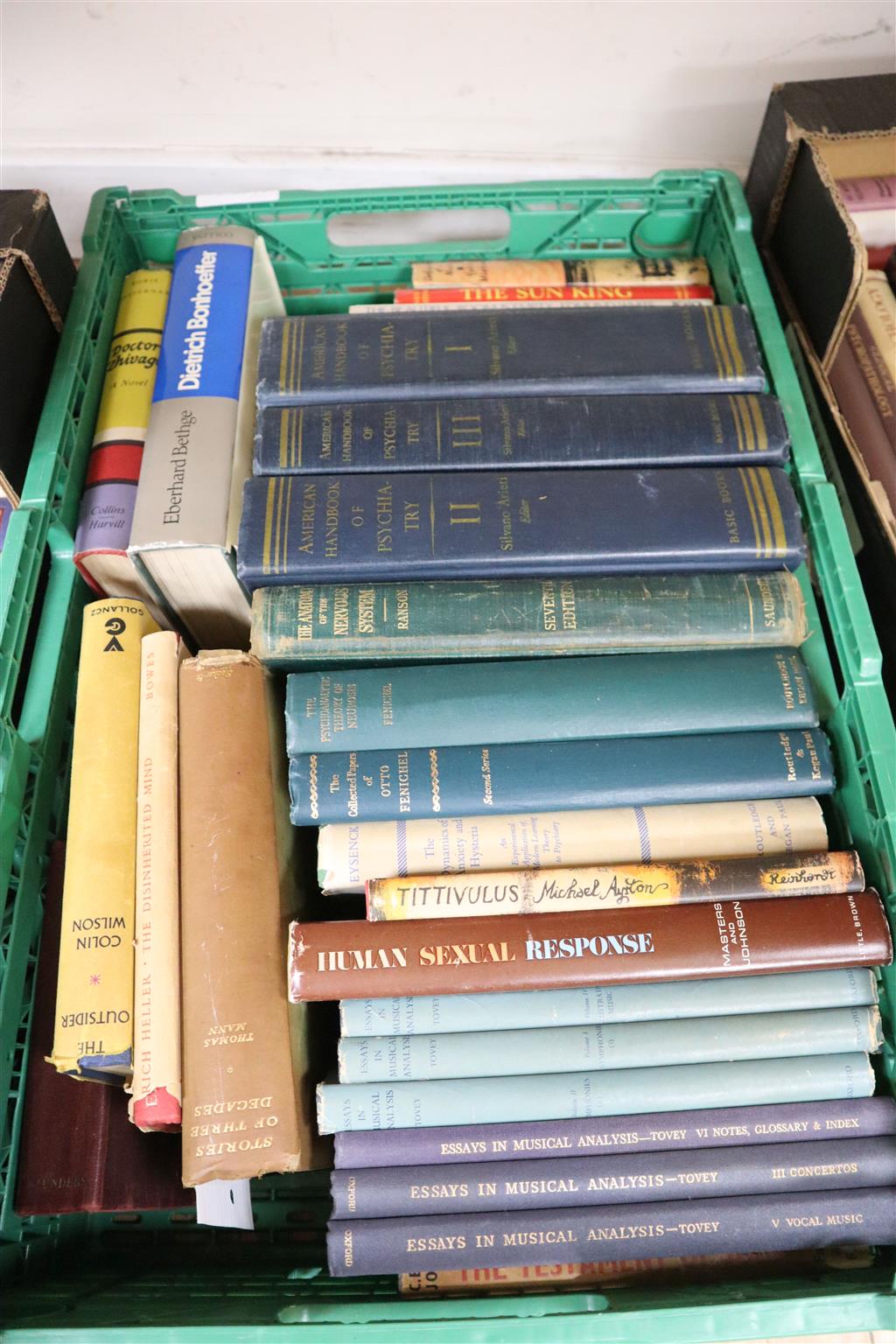 Three boxes of books, including Essays In Musical Analysis, Human Sexual Response, Tropic of Capricorn, The Divine Banquet of The Brain